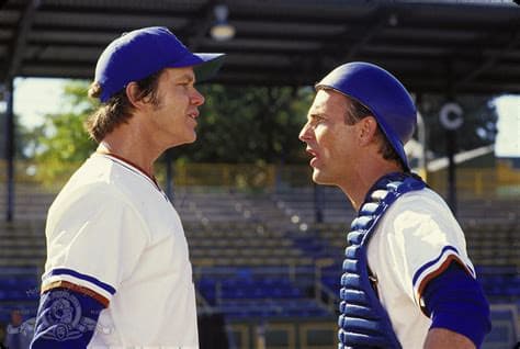 Bull Durham film still with players in conversation on the field.